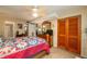 Comfortable bedroom featuring a spacious closet, ceiling fan, and tile flooring at 400 El Camino Dr # 201, Winter Haven, FL 33884