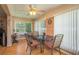 Enclosed porch used as dining area with a glass table and a view to the outside at 400 El Camino Dr # 201, Winter Haven, FL 33884