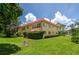 Well-maintained condo exterior with lush greenery, blue skies and manicured lawn adding to its curb appeal at 400 El Camino Dr # 201, Winter Haven, FL 33884