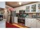 Well-lit kitchen with stainless steel appliances, granite countertops and ample cabinet space at 400 El Camino Dr # 201, Winter Haven, FL 33884