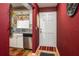 Cozy kitchen view featuring white cabinets and stainless steel appliances near the entry at 400 El Camino Dr # 201, Winter Haven, FL 33884