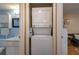 A convenient, stacked washer and dryer unit, neatly installed with access to the bathroom and living area at 400 El Camino Dr # 201, Winter Haven, FL 33884