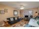 Comfortable living room area featuring a ceiling fan, cozy sofa, and functional desk space at 400 El Camino Dr # 201, Winter Haven, FL 33884