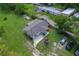 Aerial view of a single-Gathering home with a shingled roof and ample surrounding yard space at 407 Snively Ave, Winter Haven, FL 33880