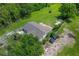 Birds eye view of a residential home showing the roof, yard, and natural green surrounding area at 407 Snively Ave, Winter Haven, FL 33880