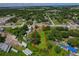 An aerial view of the lot showing its boundaries, a small house, and surroundings of trees and trailers at 407 Snively Ave, Winter Haven, FL 33880