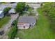 Aerial shot of the home showcases the roof, the yard, and parking in a suburban setting at 407 Snively Ave, Winter Haven, FL 33880