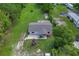 Aerial shot showcases home's placement on a spacious, well-maintained lot with mature trees at 407 Snively Ave, Winter Haven, FL 33880