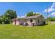 Home's backyard featuring green lawn and exterior with a small patio area at 407 Snively Ave, Winter Haven, FL 33880
