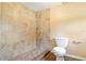 Bathroom with a fully tiled shower, a toilet, and a clean, functional design at 407 Snively Ave, Winter Haven, FL 33880