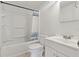 Bright bathroom featuring a shower-tub combination, toilet, and a vanity sink at 407 Snively Ave, Winter Haven, FL 33880