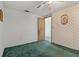 This bedroom features worn green carpet and a glimpse of the connecting bathroom at 407 Snively Ave, Winter Haven, FL 33880