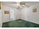 Cozy bedroom with green carpet and natural light entering through the entry way at 407 Snively Ave, Winter Haven, FL 33880