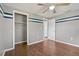 This bedroom includes wood floors, a ceiling fan, a closet, and natural light from the window at 407 Snively Ave, Winter Haven, FL 33880