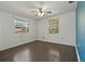 Spacious bedroom featuring wood floors, two bright windows, and a ceiling fan at 407 Snively Ave, Winter Haven, FL 33880