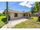 Single Gathering home exterior view with sidewalk and porch, under a clear blue sky at 407 Snively Ave, Winter Haven, FL 33880