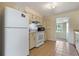 Kitchen with appliances and access to another room creates a comfortable cooking and dining experience at 407 Snively Ave, Winter Haven, FL 33880