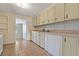 Kitchen with light cabinets, tile flooring, and modern appliances that are ready for a home chef at 407 Snively Ave, Winter Haven, FL 33880