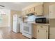 Bright kitchen featuring white appliances and a microwave, connecting seamlessly to the living area at 407 Snively Ave, Winter Haven, FL 33880