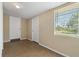 Bright, open living room features a window, neutral walls and easy-to-clean tile flooring at 407 Snively Ave, Winter Haven, FL 33880