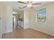 Bright living room featuring tile floors, a ceiling fan, and an open view to the kitchen at 407 Snively Ave, Winter Haven, FL 33880