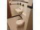 Modest bathroom featuring tiled floor, sink and toilet at 4160 Poinciana Dr, Indian Lake Estates, FL 33855