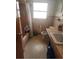Bathroom featuring a sink, toilet, shower and a small window at 4160 Poinciana Dr, Indian Lake Estates, FL 33855