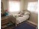 Quaint bedroom showcasing natural light, comfortable bed, and storage at 4160 Poinciana Dr, Indian Lake Estates, FL 33855