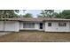 Charming single-story home featuring a red tile roof, front lawn, and attached one car garage at 4160 Poinciana Dr, Indian Lake Estates, FL 33855
