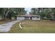 Exterior of single story home in Dunnellon, Florida features an attached single car garage and concrete driveway at 4160 Poinciana Dr, Indian Lake Estates, FL 33855