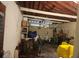 Functional garage space with wooden ceiling beams and garage door at 4160 Poinciana Dr, Indian Lake Estates, FL 33855