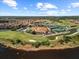 Overhead view showcasing the community clubhouse, golf course, tennis courts, and picturesque lakes throughout the property at 4254 Berwick Dr, Lake Wales, FL 33859