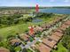 Stunning aerial view of homes near a lake, showcasing a golf course and a clubhouse at 4254 Berwick Dr, Lake Wales, FL 33859