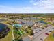 Expansive aerial view of the community clubhouse, pool, and recreational areas by the lake at 4254 Berwick Dr, Lake Wales, FL 33859