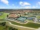 Aerial view showcasing the community clubhouse, pools, tennis courts, and picturesque lakes throughout the property at 4254 Berwick Dr, Lake Wales, FL 33859