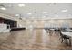 Large community ballroom with wood floors, tables, chairs, and stage with flags at 4254 Berwick Dr, Lake Wales, FL 33859