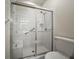 Bathroom featuring glass-enclosed shower with built-in seat and grab bar for safety at 4254 Berwick Dr, Lake Wales, FL 33859