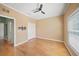 A cozy bedroom with hardwood floors features a ceiling fan, window, and closet at 4254 Berwick Dr, Lake Wales, FL 33859