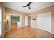 A bright bedroom with wooden floors features a ceiling fan and a closet at 4254 Berwick Dr, Lake Wales, FL 33859