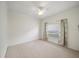A bright room has neutral walls and carpet with a window and ceiling fan at 4254 Berwick Dr, Lake Wales, FL 33859