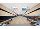 Bright bowling alley with modern scoring displays, lanes and seating for players at 4254 Berwick Dr, Lake Wales, FL 33859