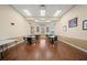 Cozy dining room with wood floors and multiple tables set for dining at 4254 Berwick Dr, Lake Wales, FL 33859
