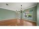 Bright dining room featuring hardwood floors, a chandelier and a large window at 4254 Berwick Dr, Lake Wales, FL 33859