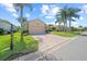 Charming home featuring a manicured lawn, brick driveway, and mature palm trees at 4254 Berwick Dr, Lake Wales, FL 33859