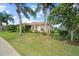 Well-manicured front yard with verdant lawn, mature trees, and a charming single-story residence at 4254 Berwick Dr, Lake Wales, FL 33859