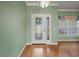 Entryway with decorative glass front door, hardwood floors, and a window providing natural light at 4254 Berwick Dr, Lake Wales, FL 33859