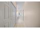 Hallway with tile flooring leading to bathroom, showcasing closet and access to other rooms at 4254 Berwick Dr, Lake Wales, FL 33859