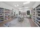 Well-lit library with bookshelves, tables, chairs, and a cozy reading area at 4254 Berwick Dr, Lake Wales, FL 33859