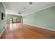 Large living room with hardwood floors, ceiling fan and sliding glass doors leading to outdoor space at 4254 Berwick Dr, Lake Wales, FL 33859