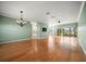 Spacious living room featuring hardwood floors, chandelier, and access to the lanai at 4254 Berwick Dr, Lake Wales, FL 33859